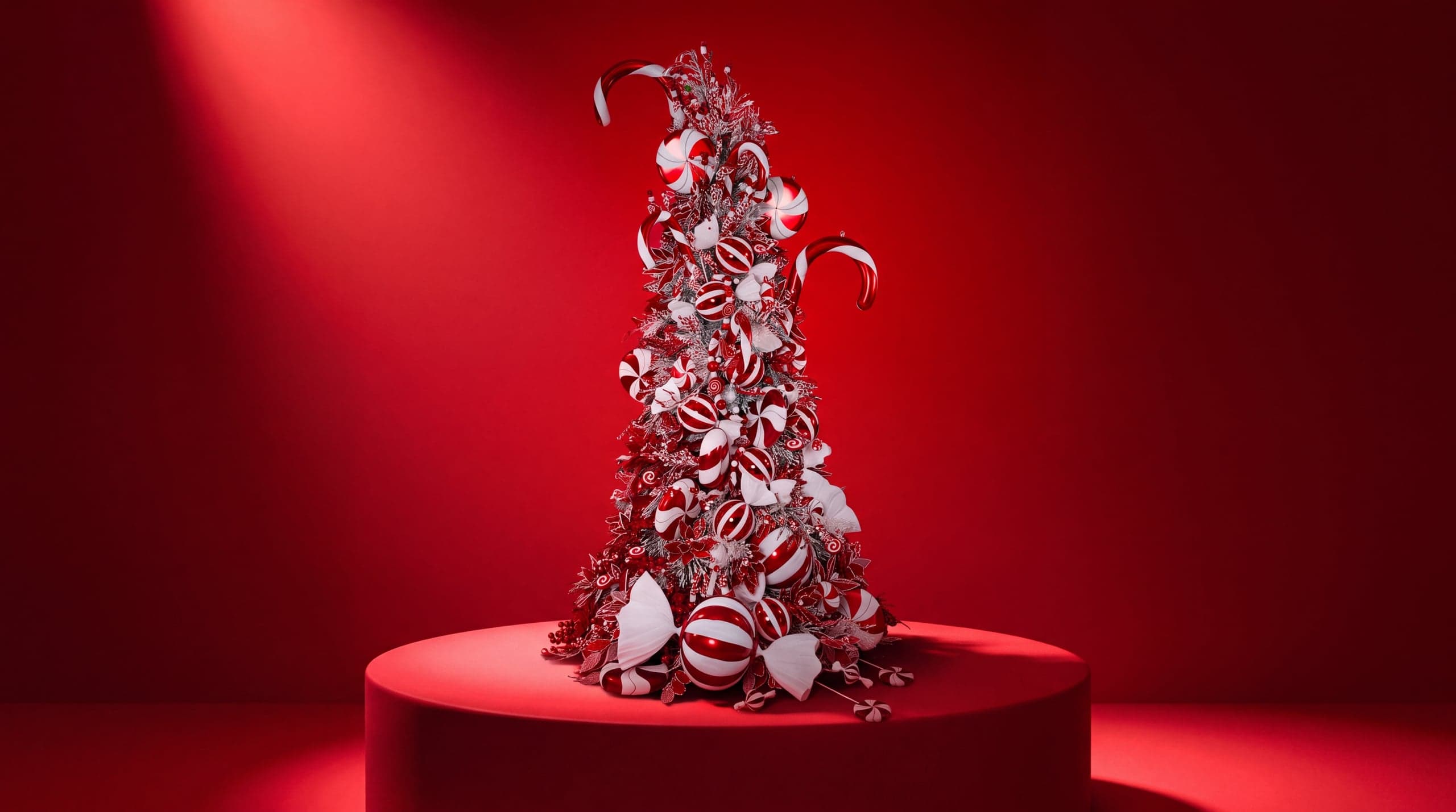 The Candy Cane Tree on a red podium against a red backdrop in the studio